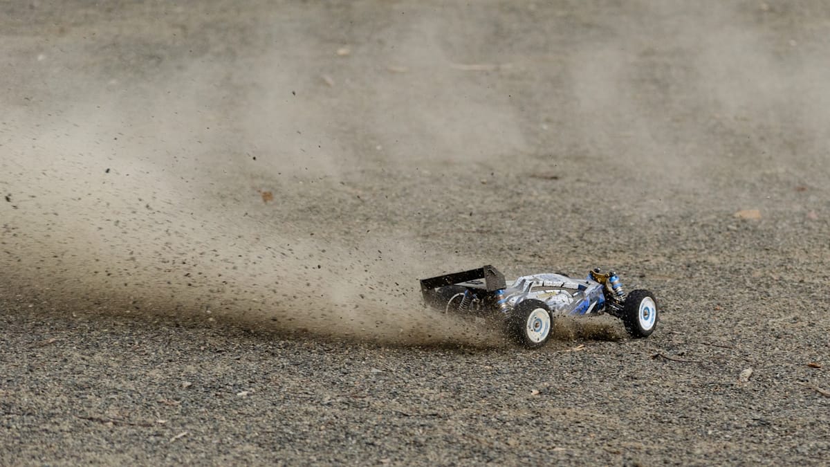 RC off-road buggy kicking up dust mid-race