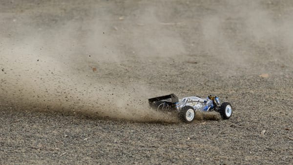 RC off-road buggy kicking up dust mid-race