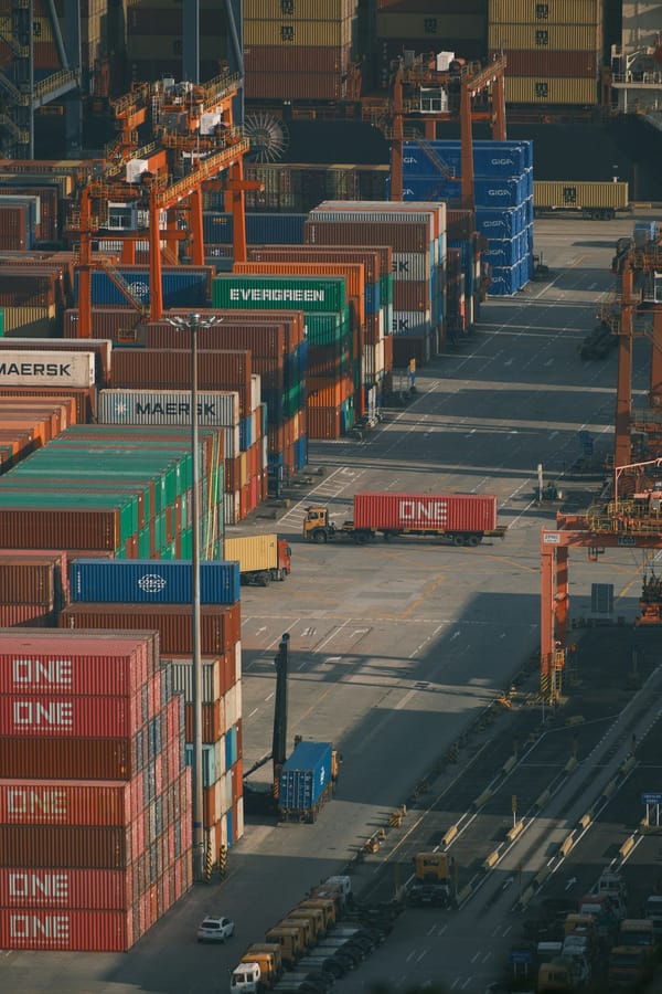 Shipping containers stacked at a busy port